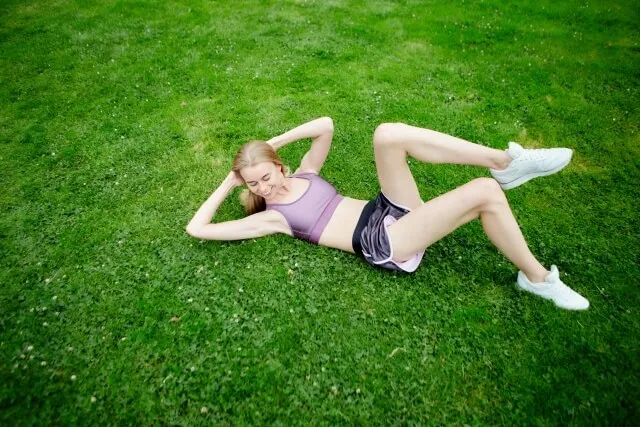 woman stretch on grass