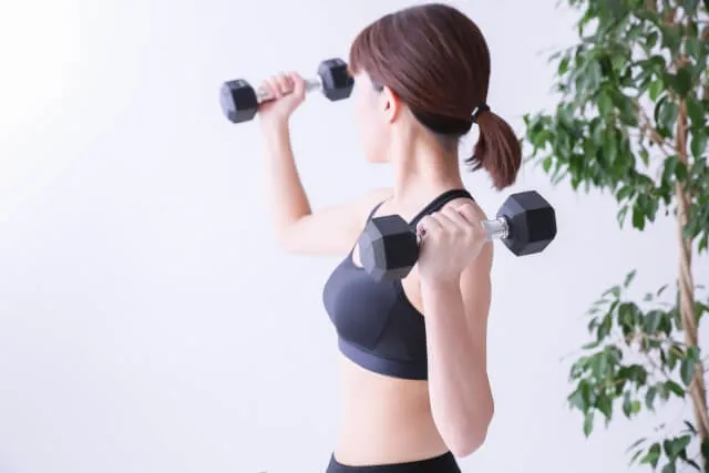 woman training with dumbbell